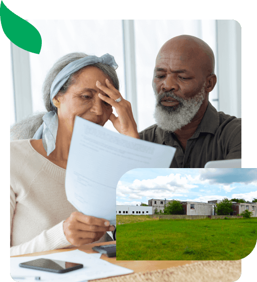 A couple reviewing paperwork about their vacant land